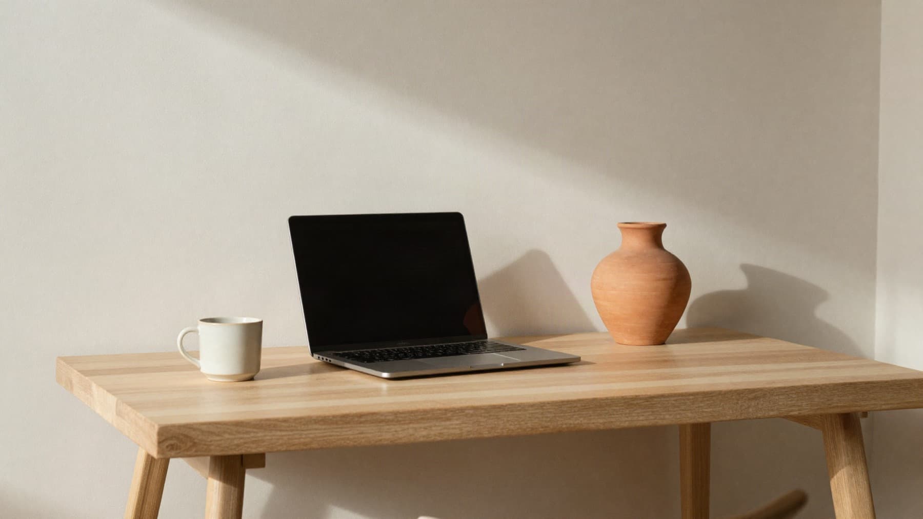 A calm, minimal remote workspace in warm natural light